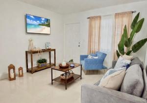 a living room with a couch and a table at Miami Blue Oasis l 2BR with free parking in Miami