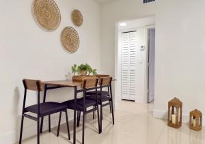 a dining room with a wooden table and chairs at Miami Blue Oasis l 2BR with free parking in Miami
