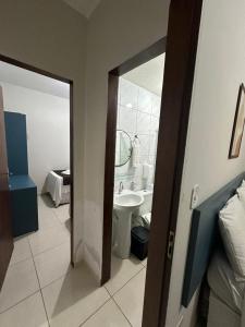 a bathroom with a sink and a mirror at Pousada Caribe Brasileiro in Maragogi