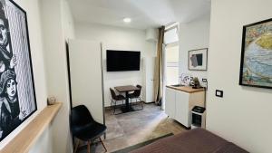 a room with a bed and a desk with a chair at City Room Filip without window in Poreč +8 photos