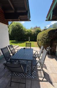 a blue table and chairs on a patio at Chalet Lilly inkl. Chiemgaukarte in Ruhpolding