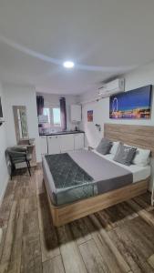a bedroom with a large bed and a chair at hostal olozaga in Alicante