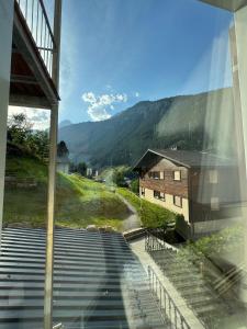 a view of a building from a window with stairs at Blue Ocean in Göschenen