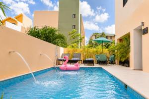 a pool with a pink flamingo in the water at Hotel Boutique Mura in Cancún