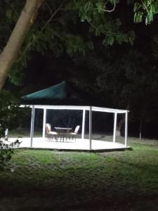 a gazebo with two chairs and a table at Royal Heritage Lodges in Bahawalpur