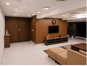 a large living room with a tv and a couch at Cecil Apartments On Mall Road Murree in Murree +5 photos