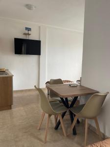 a dining room with a wooden table and chairs at Sunrise Apartments and Studios in Star Dojran