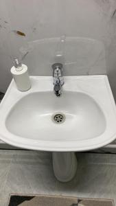 a white sink in a bathroom with a toilet at Amir in Arkit