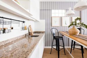 a kitchen with a counter and a dining table at Top Rentals Palermo Chico in Buenos Aires +17 photos
