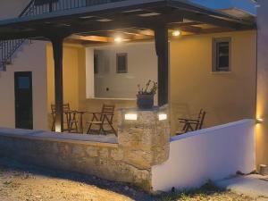 a patio of a house with a table and chairs at Irene Studios in Nydri