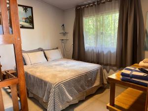 a bedroom with a bed and a window at Rancho dos Ipês Corumbá in Alexânia +109 photos