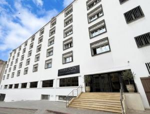 a white building with a staircase in front of it at Hamilton Suites & Appart in Casablanca