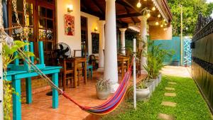 a porch with a hammock on a patio at Ceylon Glory Hostel in Negombo
