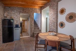 a kitchen and dining room with a table and a refrigerator at MARIA'S Roof Top View in Poros