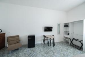 a living room with a table and a chair at B&B Francy and sons in Modugno