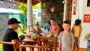 a group of people sitting at a table in a restaurant at Ceylon Glory Hostel in Negombo