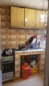 a kitchen with wooden cabinets and a stove top oven at Sejeva in Ikorodu