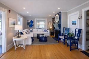 a living room with a white couch and blue chairs at Blue Shutters Inn and Studios in Ogunquit