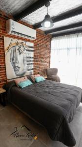 a bedroom with a large bed in a brick wall at Loft Estilo Industrial in Ezeiza +34 photos