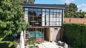 a house with a pool inside of it at Loft Estilo Industrial in Ezeiza