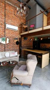 a room with a table and chairs and a brick wall at Loft Estilo Industrial in Ezeiza