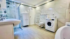 a bathroom with a washing machine and a toilet at Marevista in Dramalj