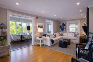 a living room with a white couch and a table at Blue Shutters Inn and Studios in Ogunquit