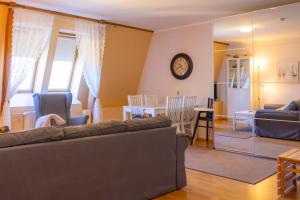 a living room with a couch and a dining room at Bright Apartment in Haapsalu in Haapsalu