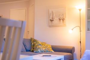 a living room with a couch and a table at Bright Apartment in Haapsalu in Haapsalu