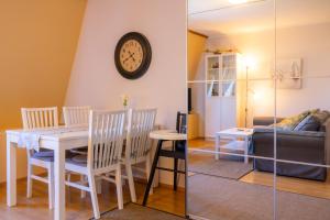 a dining room and living room with a table and chairs at Bright Apartment in Haapsalu in Haapsalu +14 photos