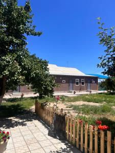 a wooden fence in front of a building at House Saadat in Tossor +4 photos