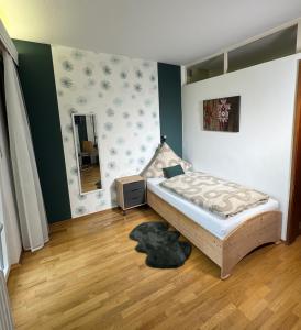 a bedroom with a bed and a mirror on the wall at Haus Hubertus in Bad Peterstal-Griesbach
