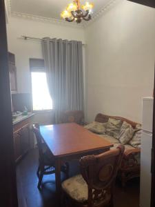 a living room with a table and a couch at Dyrrah Rooms Central in Durrës