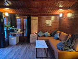 a living room with a couch and a table at Cabin39 in Barkingside