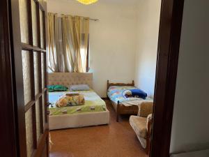a room with two beds and a window at Dyrrah Rooms Central in Durrës +8 photos