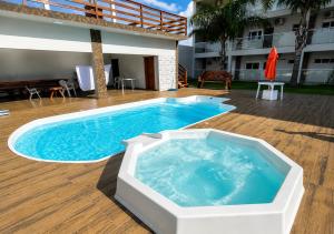 a large swimming pool sitting next to a building at Hotel Vanguarda Tapera in Tapera