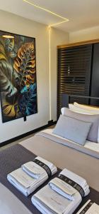 a hotel room with two beds with towels on them at The Altitude Cabana 1373-Concrete in Mundo Novo