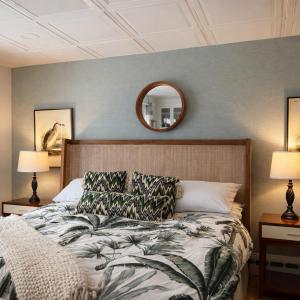 a bedroom with a bed and a mirror on the wall at Blue Shutters Inn and Studios in Ogunquit