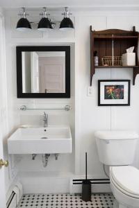 a white bathroom with a sink and a toilet at Blue Shutters Inn and Studios in Ogunquit +29 photos
