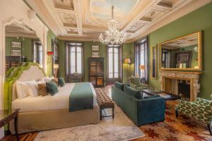 a bedroom with a bed and a fireplace and a chandelier at Palazzo Trezza in Verona