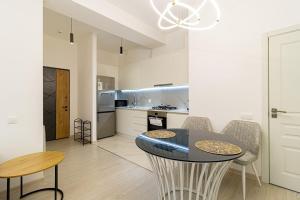 a kitchen and dining room with a table and chairs at Stylish 2BR Apartment in Yerevan in Yerevan