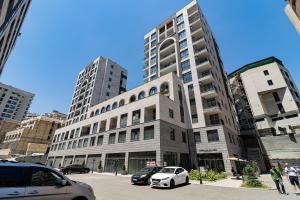 a tall building with cars parked in front of it at Stylish 2BR Apartment in Yerevan in Yerevan