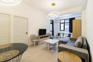 a living room with a couch and a table at Stylish 2BR Apartment in Yerevan in Yerevan