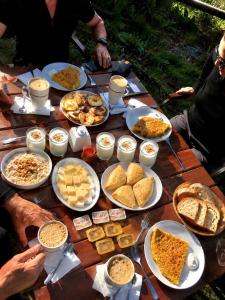 a wooden table with plates of food on it at Qaldea Resort in Ushguli