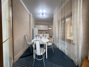 a kitchen with a table and chairs in a room at Kapshagay Lake in Kapchagay
