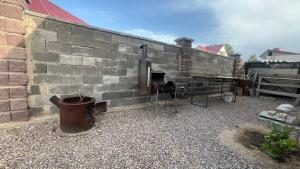 a brick wall with a toilet in front of it at Kapshagay Lake in Kapchagay +3 photos