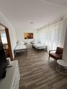 a living room with two beds and a couch at Das kleine Zuhause 1 in Bad Driburg