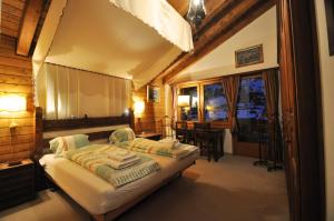 a bedroom with a bed and a table and a window at Haus Tiefbach - Apartment Cervino in Zermatt