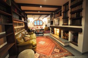 a living room with a couch and a fireplace at Haus Tiefbach - Apartment Cervino in Zermatt