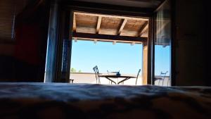 a bedroom with a bed and a table and a window at Terrazza Tosti in Formia